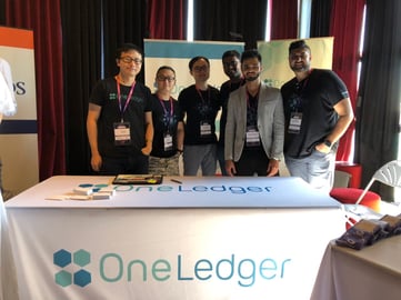 OneLedger team at the booth